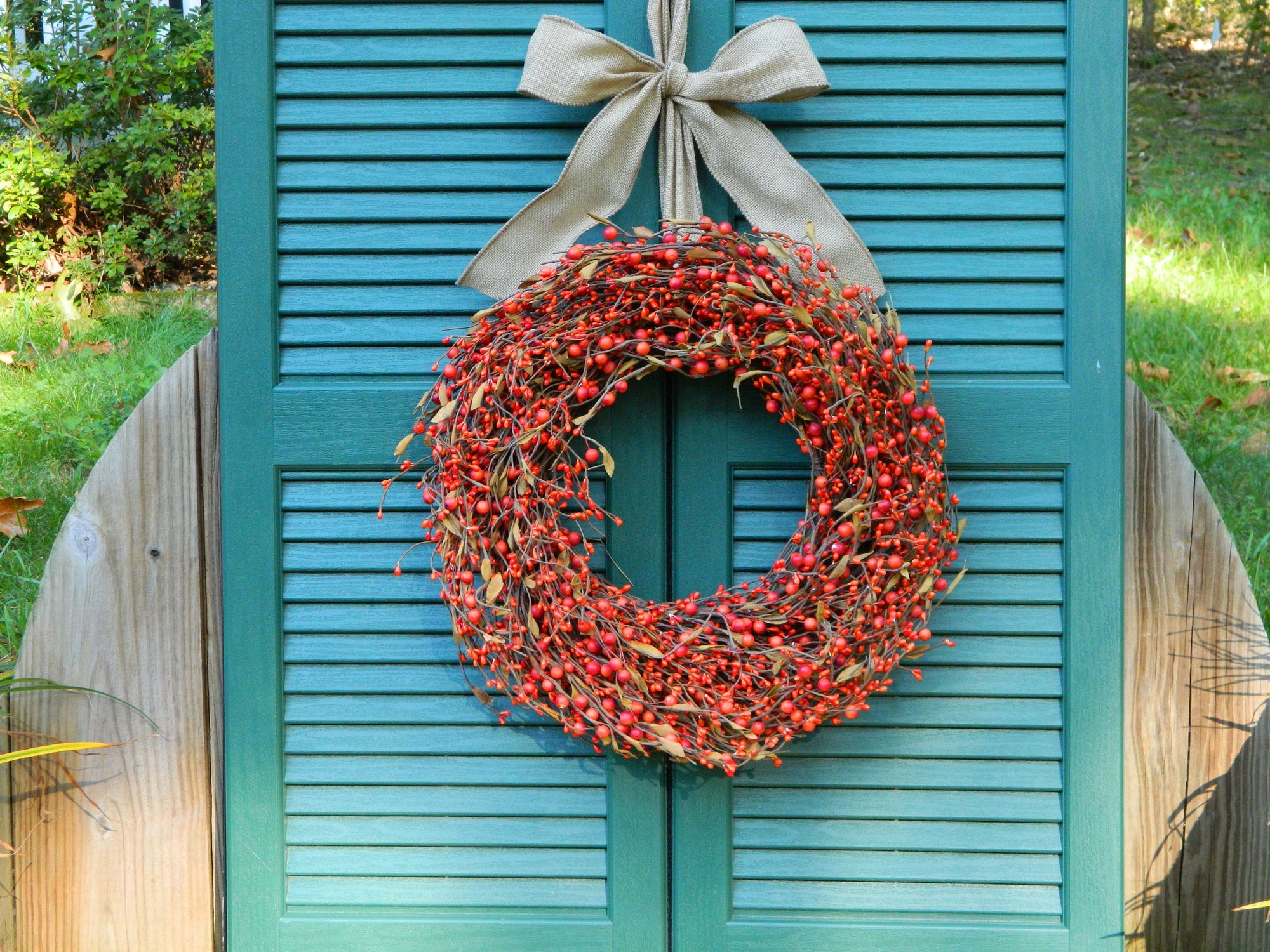 Orange Berry Wreath with Brown Leaves with Bow